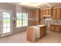 Bright kitchen with natural wood cabinets, central island, and natural light offering potential for a dream kitchen at 835 Emmett Ct, Spring Hope, NC 27882