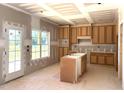Bright kitchen features natural wood cabinets, a center island, and natural light ready to be personalized at 835 Emmett Ct, Spring Hope, NC 27882