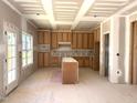 Unfinished kitchen with natural wood cabinets, a central island, and plenty of natural light ready to be customized at 835 Emmett Ct, Spring Hope, NC 27882