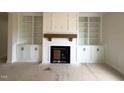 Living room showcasing a fireplace with custom built-in shelving at 835 Emmett Ct, Spring Hope, NC 27882