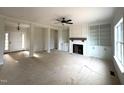 Open-concept living room featuring a fireplace and custom built-in shelving at 835 Emmett Ct, Spring Hope, NC 27882