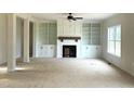 Spacious living room with custom built-in shelving and a cozy fireplace at 835 Emmett Ct, Spring Hope, NC 27882