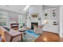 Bright living room with fireplace, built-in shelving, and a skylight for natural light at 10 E Madison, Pittsboro, NC 27312