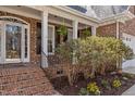 Inviting front porch with brick steps, white columns, and lush landscaping at 101 Barriedale Cir, Cary, NC 27519