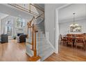 Elegant staircase leading to the second floor, with views of the living room and dining area at 101 Barriedale Cir, Cary, NC 27519