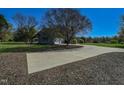 Long driveway leading to a charming two-story home with an attached garage and large front lawn at 10317 Lake Wheeler Rd, Fuquay Varina, NC 27526
