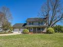 Charming two-story home with a two-car garage, large lawn, and mature landscaping at 10317 Lake Wheeler Rd, Fuquay Varina, NC 27526