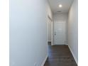 Bright hallway with dark hardwood floors, leading to other areas of the home at 105 Village Dr, Broadway, NC 27505