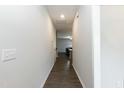 Hallway with hardwood floors, connecting to a spacious living area at 105 Village Dr, Broadway, NC 27505