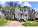 Charming two-story home with a welcoming front porch and well-maintained landscaping at 1052 Mills Street, Raleigh, NC 27608
