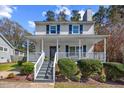 Inviting front porch with rocking chairs and a swing, perfect for relaxing outdoors at 1052 Mills Street, Raleigh, NC 27608