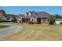 Attractive single-Gathering brick home with landscaped lawn and curved driveway at 1055 Tilghman Rd, Dunn, NC 28334