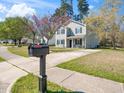 Attractive two-story home with a well-manicured lawn, concrete driveway, and an inviting front entrance at 106 Mingocrest Dr, Knightdale, NC 27545