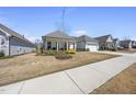 Street view of a home with a well-maintained lawn and beautiful landscaping in a suburban neighborhood at 1113 Cryptic Wood Ave, Fuquay Varina, NC 27526
