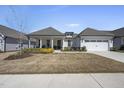 Charming single-story home with a covered porch and well-manicured front yard and two car garage at 1113 Cryptic Wood Ave, Fuquay Varina, NC 27526