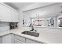Bright kitchen with white cabinets, quartz countertops, subway tile backsplash, and stainless steel sink at 1121 Parkridge Ln # 207, Raleigh, NC 27605