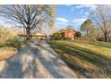 Long concrete driveway leads to the house and carport at 1122 Snow Hill Rd, Durham, NC 27712