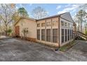 Sun room with multiple windows, providing natural light and views of the outdoors at 1122 Snow Hill Rd, Durham, NC 27712