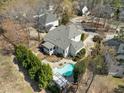 Aerial view of a backyard featuring a sparkling pool, patio area, and lush landscaping at 116 Arlen Park Pl, Holly Springs, NC 27540