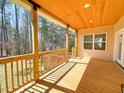 Spacious back porch with wood flooring and ceiling, ideal for entertaining and relaxing at 1220 E Middleton Dr, Creedmoor, NC 27522