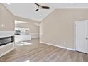 Bright living room featuring an electric fireplace, ceiling fan, and wood-look flooring at 133 Mohawk Dr, Louisburg, NC 27549