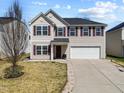 Charming two-story home featuring a two-car garage, inviting front entrance, and well-kept landscaping at 151 Kutter Dr, Elon, NC 27244