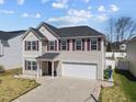 Well-maintained two-story home with a two-car garage, landscaped yard, and a welcoming front entrance at 151 Kutter Dr, Elon, NC 27244