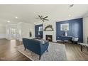 Inviting living room boasts a cozy fireplace, modern ceiling fan, and stylish decor for comfortable living at 1720 Highpoint St, Wake Forest, NC 27587