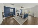 Bright living room with a fireplace, ceiling fan, and large windows offering plenty of natural light at 1720 Highpoint St, Wake Forest, NC 27587
