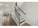 Elegant staircase featuring wood treads, decorative iron spindles, and stylish trim, leading to the upper level at 1720 Highpoint St, Wake Forest, NC 27587