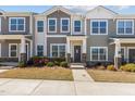 Charming townhome exterior with stone accents, a welcoming entrance, and well-maintained landscaping at 1805 Kauri Cliffs Dr, Fuquay Varina, NC 27526