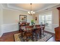 Elegant dining room with dark wood floors and wainscoting at 187 Moss Creek Pl, Fuquay Varina, NC 27526