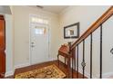 Welcoming foyer with wood floors, staircase, and a decorative rug at 187 Moss Creek Pl, Fuquay Varina, NC 27526