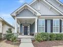 Inviting front porch with stone accents, seating and stylish exterior at 2013 Big Falls Dr, Wendell, NC 27591
