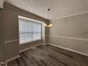 Cozy dining area with a window for natural light and laminate flooring at 2109 Henniker St, Apex, NC 27523