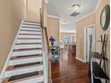 Inviting foyer with hardwood floors, staircase, and views into the living spaces at 2216 Tanners Mill Dr, Durham, NC 27703