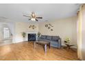 Cozy living room featuring a fireplace, ceiling fan, and ample space for relaxation and entertainment at 2245 Ventana Ln, Raleigh, NC 27604