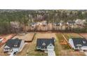Aerial view of a home with a large backyard backing up to wooded area and a storage building at 240 Northview Dr, Middlesex, NC 27557