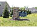 Community sign reading North Creek Meadows in a well landscaped neighborhood with grassy areas and trees at 240 Northview Dr, Middlesex, NC 27557