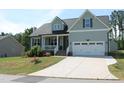Charming two-story home with a well-manicured lawn, covered porch, and a two-car garage at 240 Northview Dr, Middlesex, NC 27557