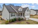 Charming home featuring a 2-car garage, inviting front porch, manicured lawn, and stylish exterior finishes at 240 Northview Dr, Middlesex, NC 27557
