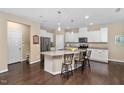 Bright and airy kitchen with granite countertops, stainless steel appliances, and a large island with seating at 2422 Pecan Ridge Way, Apex, NC 27502
