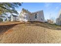Back exterior view of single story home with vinyl siding and green spaces at 2613 Lilymount Dr, Raleigh, NC 27610