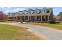 Charming brick home with a welcoming front porch and a gravel driveway in a country setting at 3030 Old Stage S Rd, Erwin, NC 28339
