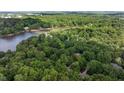 Overhead view of a secluded wooded neighborhood with lake access at 306 Lochside Dr, Cary, NC 27518