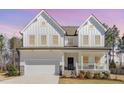 Charming two-story white farmhouse with a welcoming front porch and well-maintained landscaping at 31 E Dentaires Way, Willow Springs, NC 27592