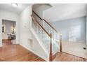 View of the entryway featuring a staircase with carpeted steps, light walls, and hardwood floors at 3308 Forest Mill Cir, Raleigh, NC 27616
