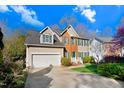 Two-story home with attached garage, brick and siding exterior, with a well-maintained lawn and landscaping at 3308 Forest Mill Cir, Raleigh, NC 27616