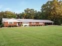 Charming brick ranch with a well-manicured lawn and a convenient covered carport at 3680 15-501 N, Pittsboro, NC 27312