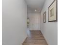 Inviting home hallway featuring wood floors and neutral paint at 402 Suhani Ln, Clayton, NC 27520